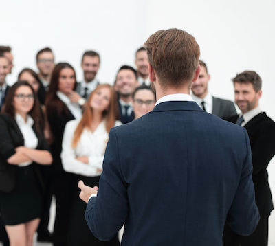 project leader standing in front of his team