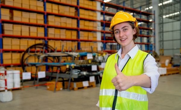 Warehouse worker after a 5S campaign in an organized and safe workspace.